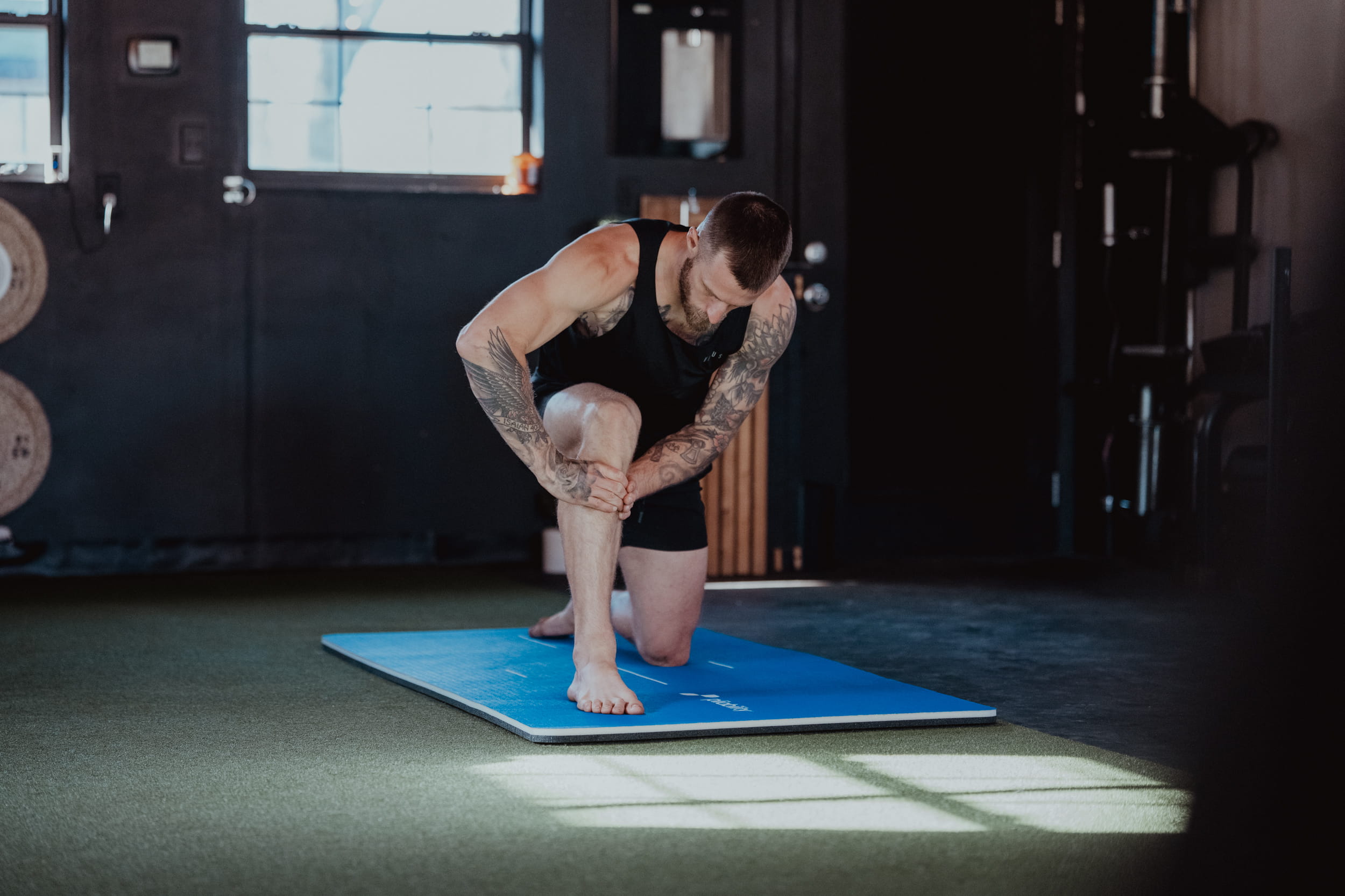 person fixing knee - What Causes Knee Stiffness