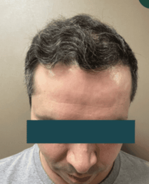 A close up of a person wearing a pair of earrings