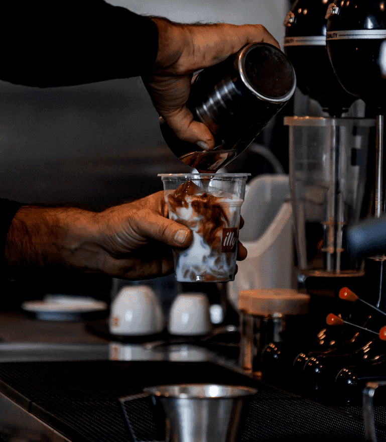 Specialty coffee preparation at a rustic neighbourhood café with walnut timber interiors — topos design studio Nicosia Cyprus