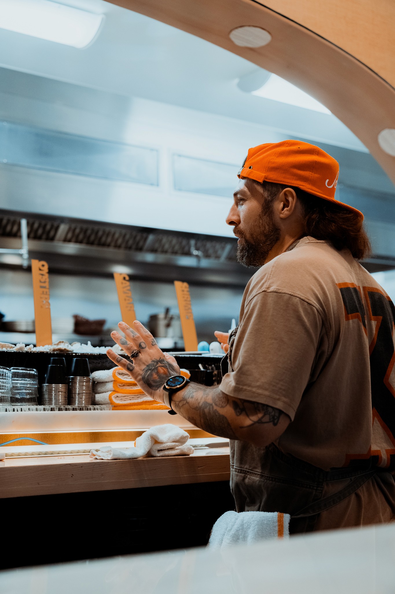 Chef Sammy Monsour standing in front of kitchen window in Joyce Soul & Sea in Los Angeles.