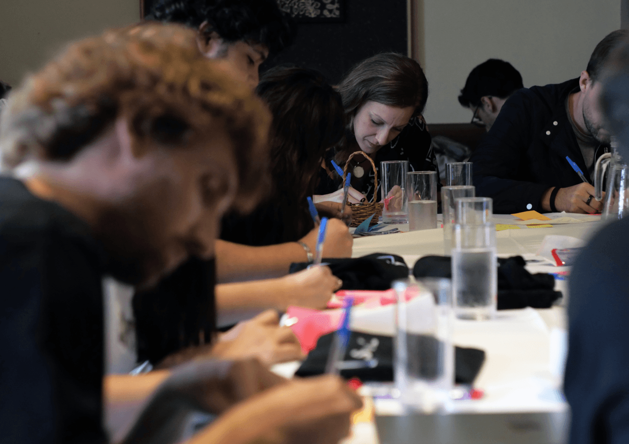 Team members writing Post Its in a bonding activity