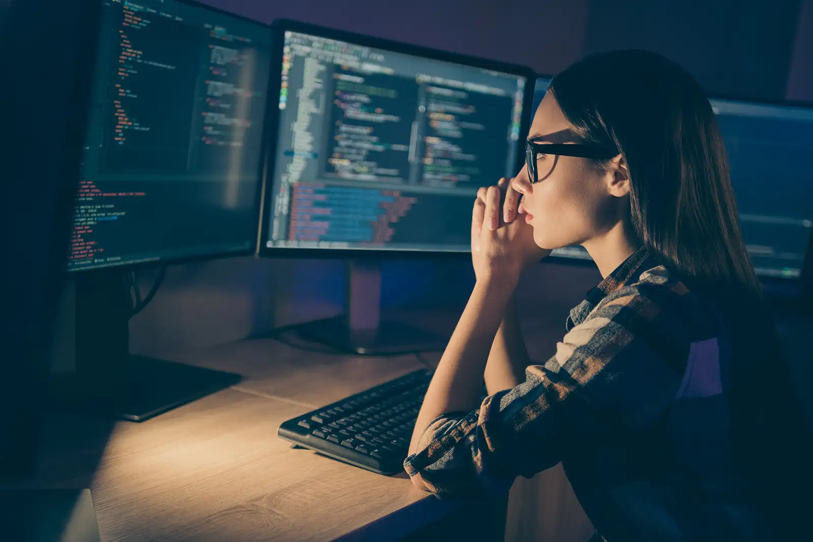 Software developer sitting at a desk reviewing code