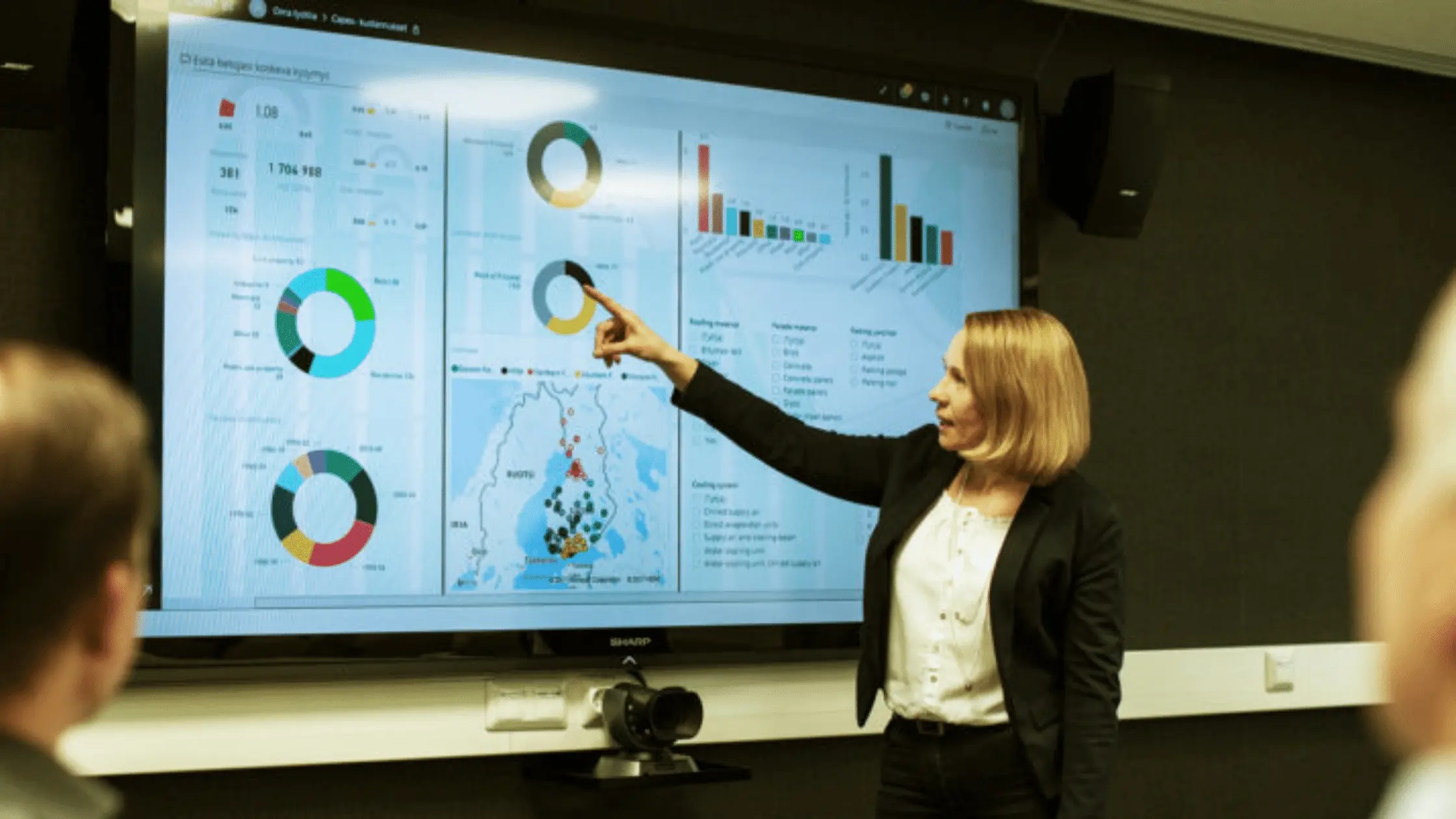 Team of people discussing the data base using graphical charts, image