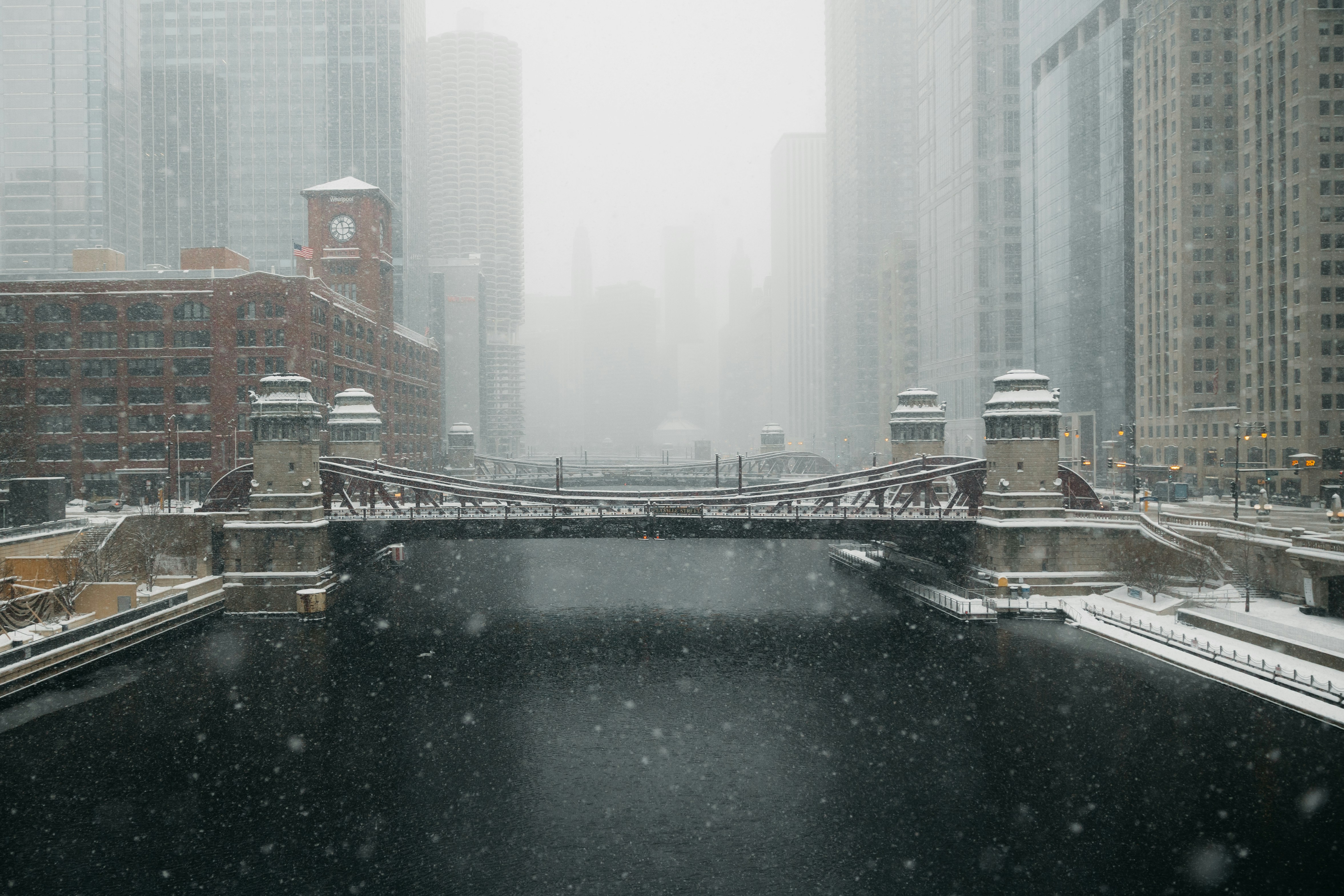 A bridge over a river during a snowstorm