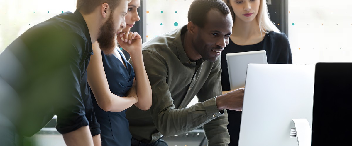 people looking at a screen standing up