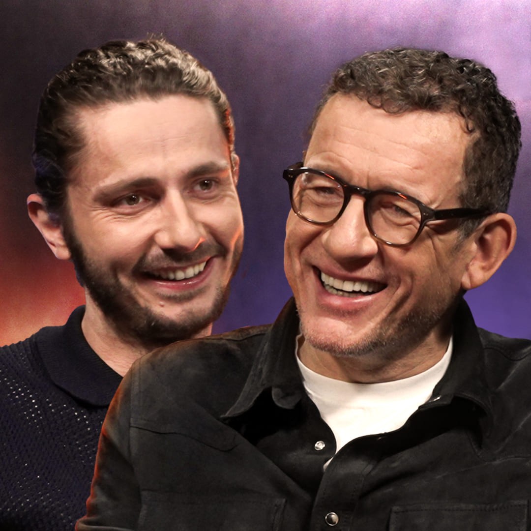 Miniature Podcast/Vidéo réalisée par Nux-Studio pour le média Legend, mettant en scène Guillaume Pley (à gauche, souriant, cheveux attachés) interviewant l'acteur et humoriste français Dany Boon (à droite, portant des lunettes et une chemise foncée, riant). Les deux sujets sont en gros plan, affichant une expression de joie et de convivialité, typique des interviews divertissantes. L'arrière-plan présente des couleurs sombres avec des lumières d'ambiance violettes et rouges. Ce visuel de direction artistique est conçu pour la création de miniatures YouTube (thumbnails) à fort CTR, ciblant des interviews de célébrités et de personnalités du cinéma.