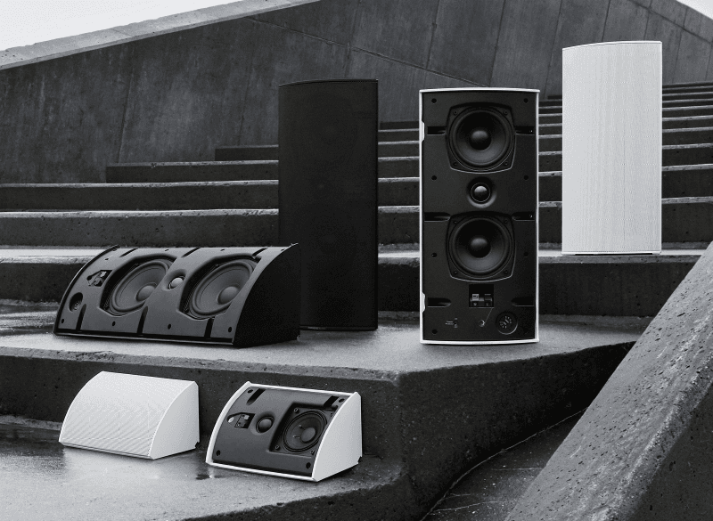 Various outdoor speakers on concrete steps.