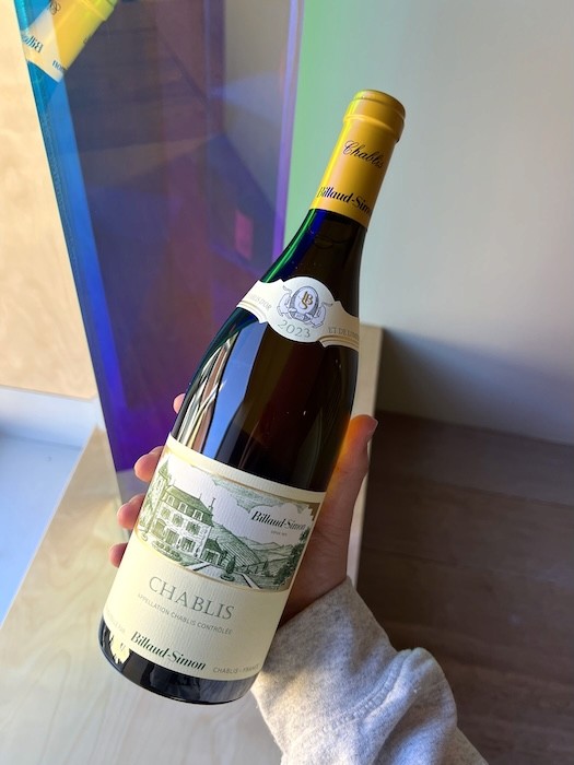 Hand holding bottle of Billaud-Simon