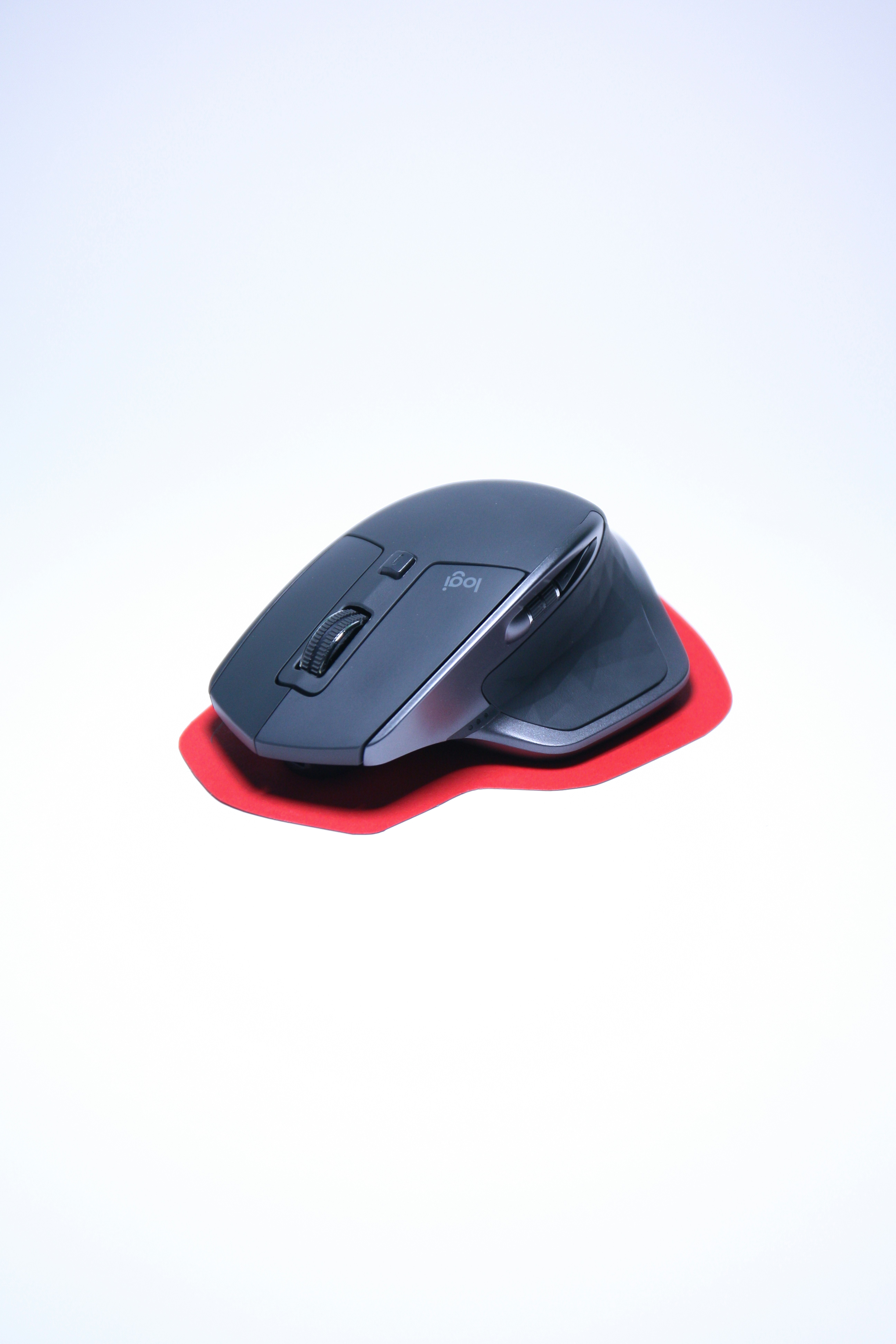 a black computer mouse sitting on top of a white table