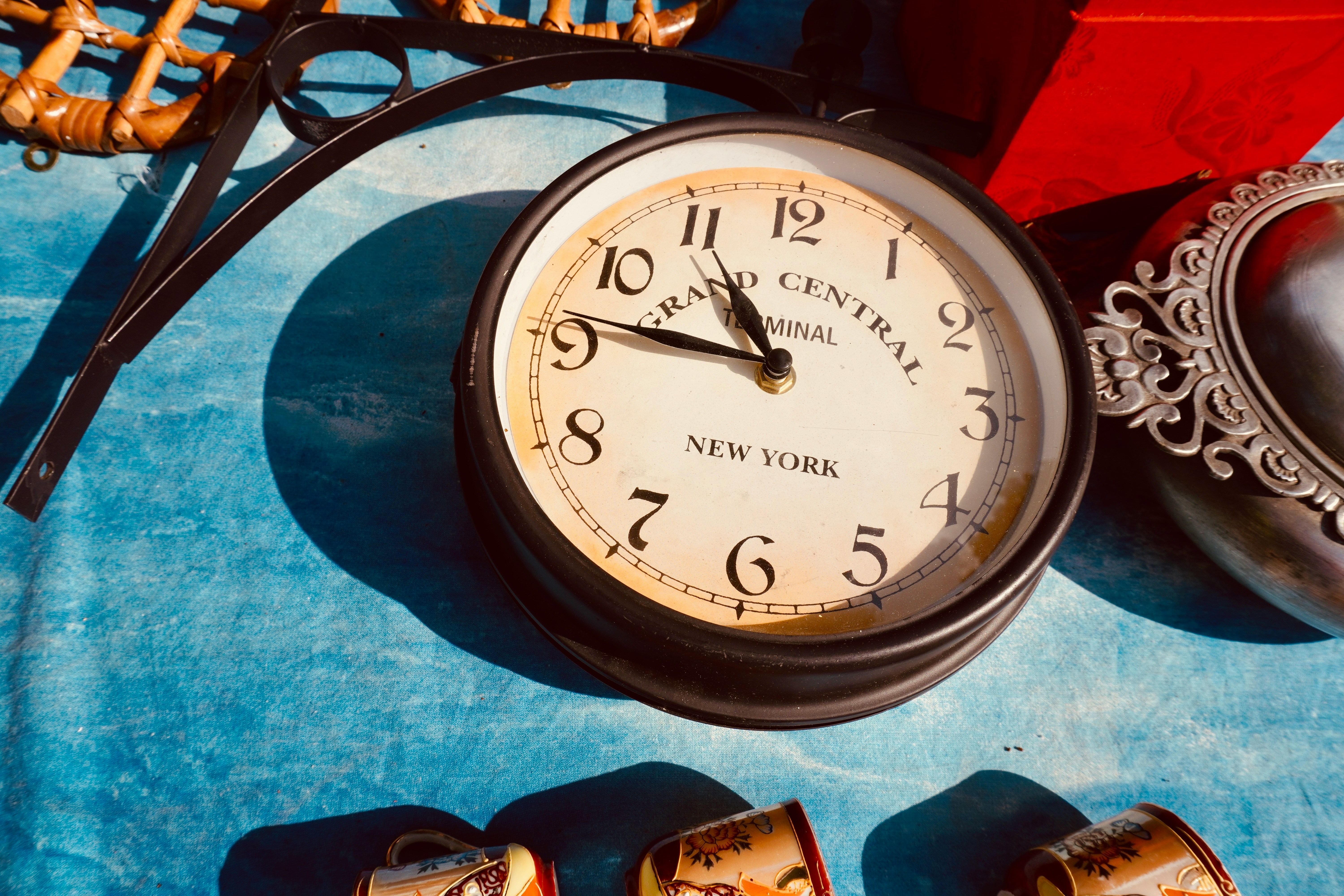 a clock sitting on top of a blue table