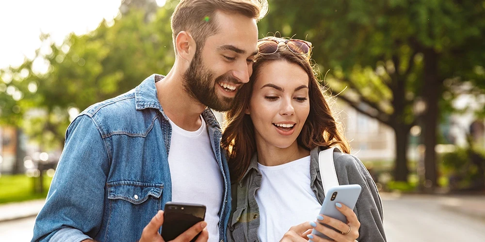 Young couple in love walking outdoors at the city street.