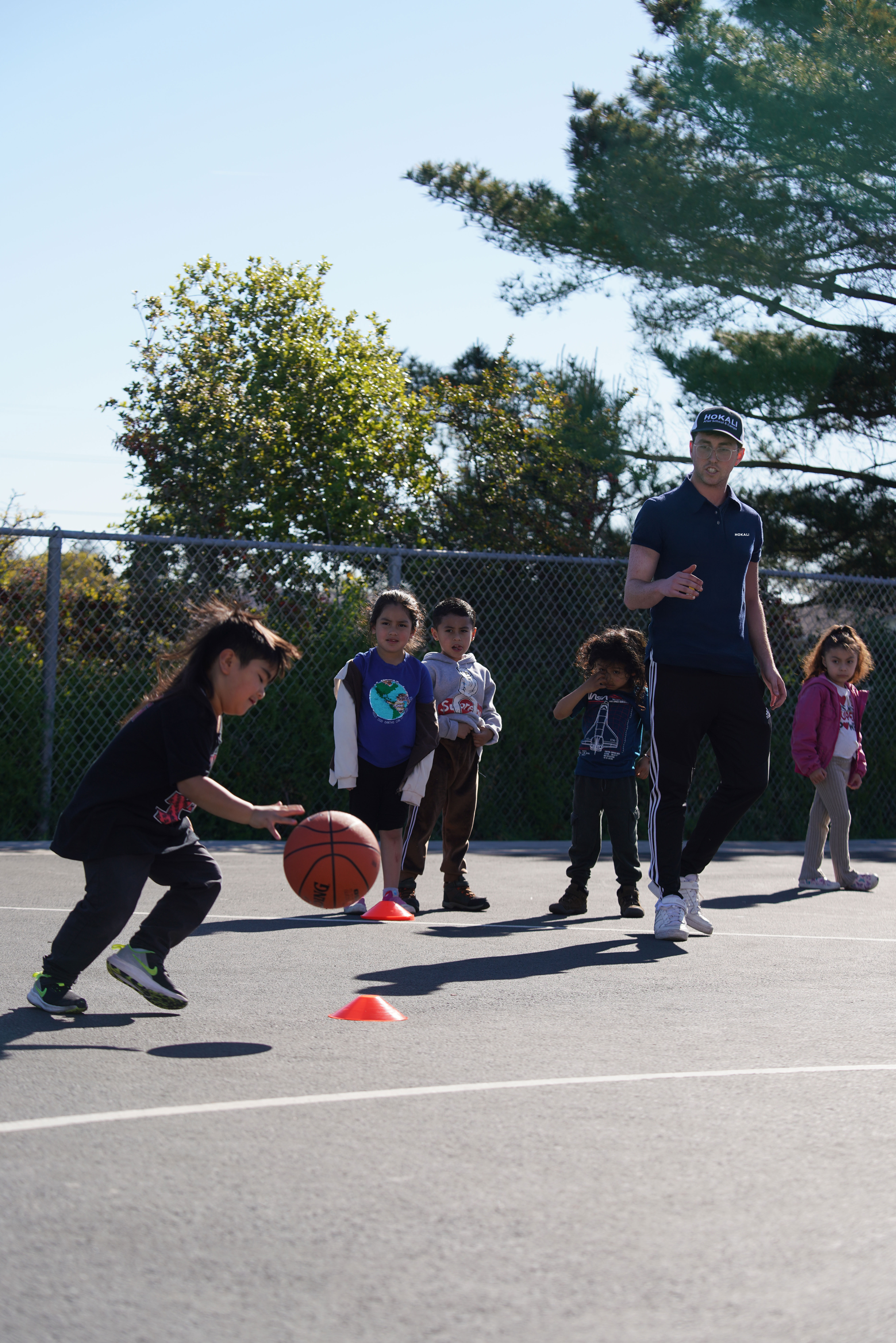Outdoor sports games at a HOKALI summer camp promoting movement, teamwork, and fun