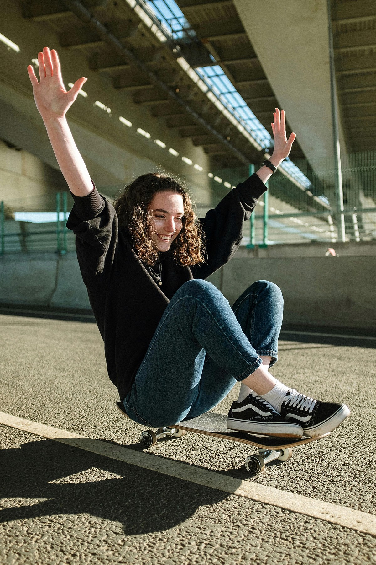 Girl riding a skateboard while sitting