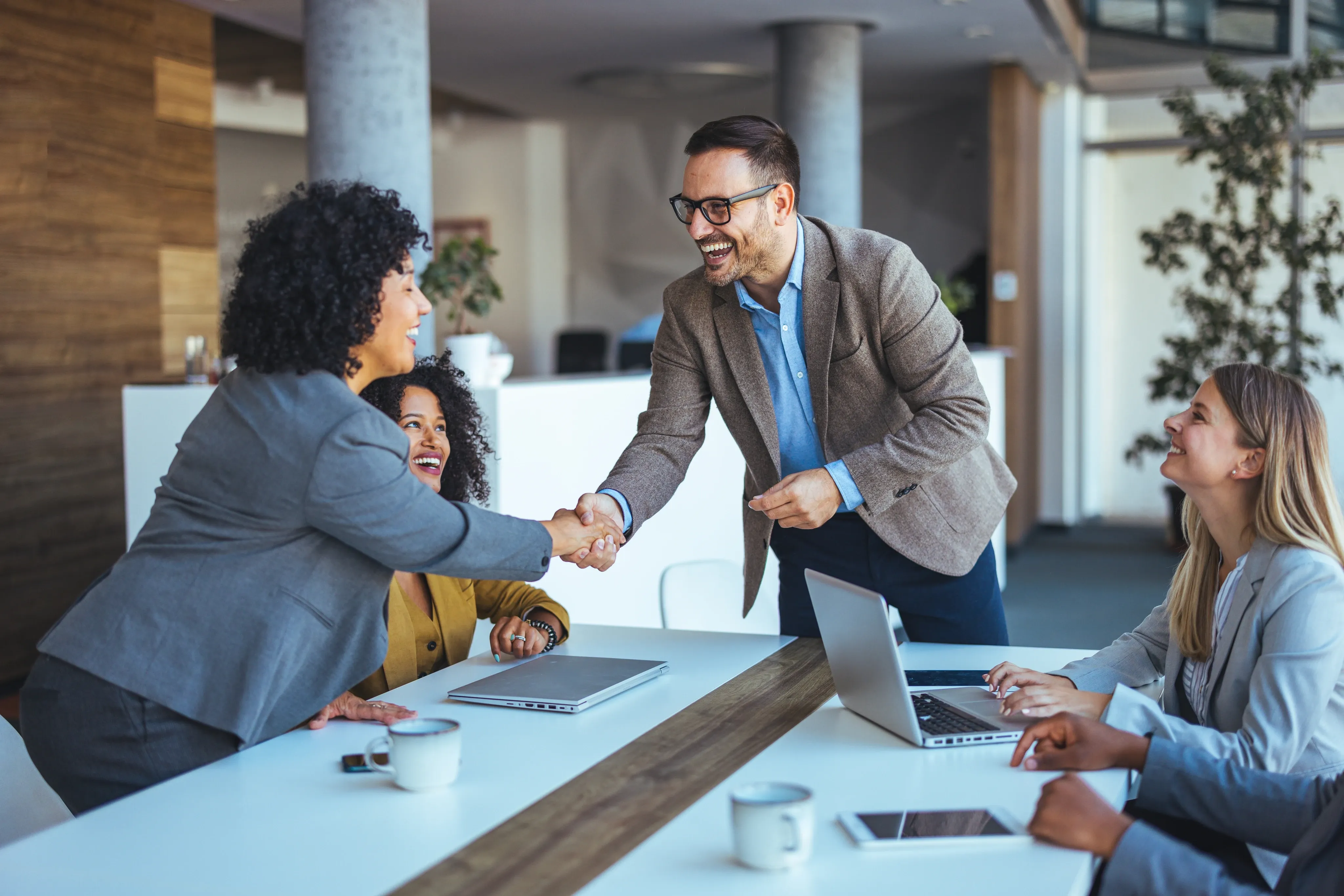 Businesspeople shaking hands and smiling