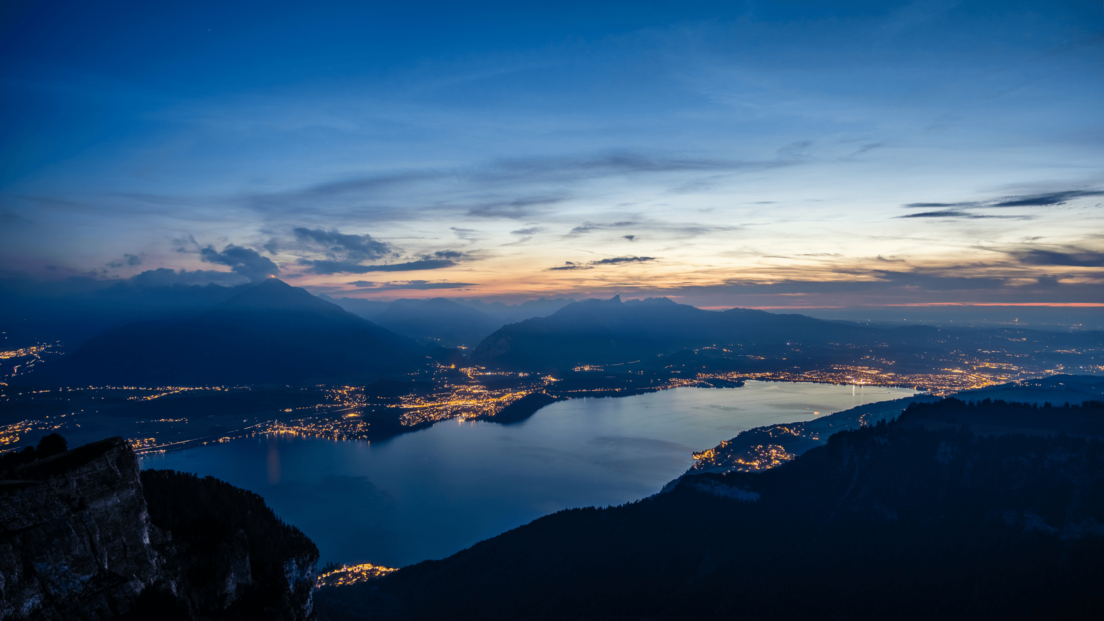woman in blue tank top standing beside white wall