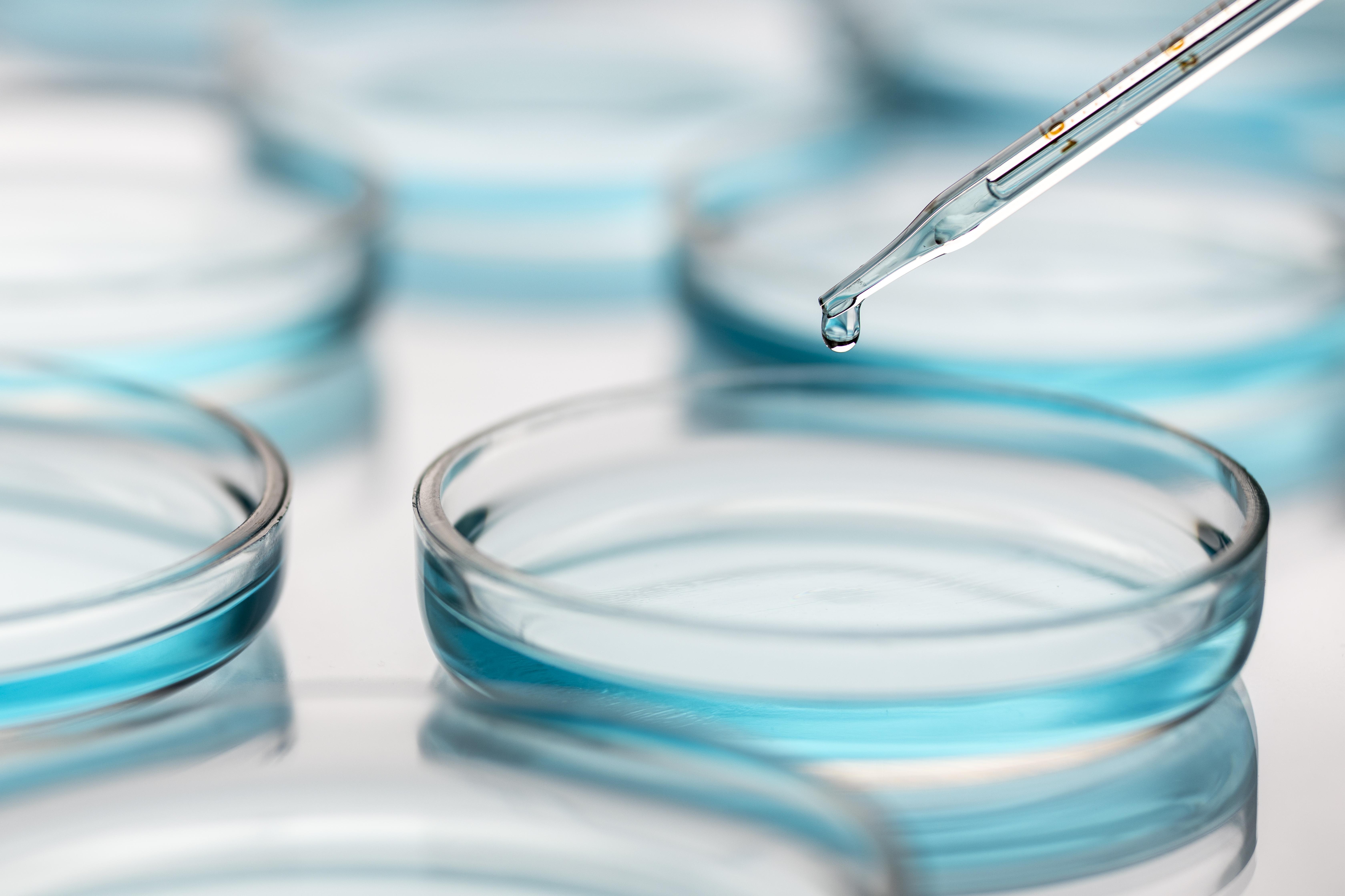 A syringe inside a glass vial, illustrating biomanufacturing automation in the pharmaceutical industry.