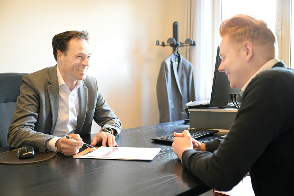Professionals discussing documents together in a modern office