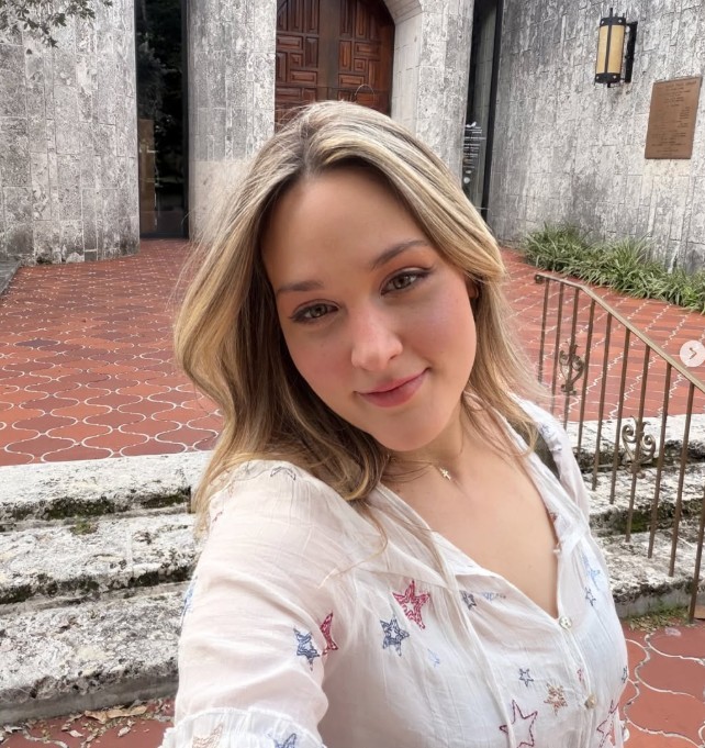 Silhouetted profile of a person in a turtleneck against a teal background. Soft lighting creates a dramatic and contemplative mood.