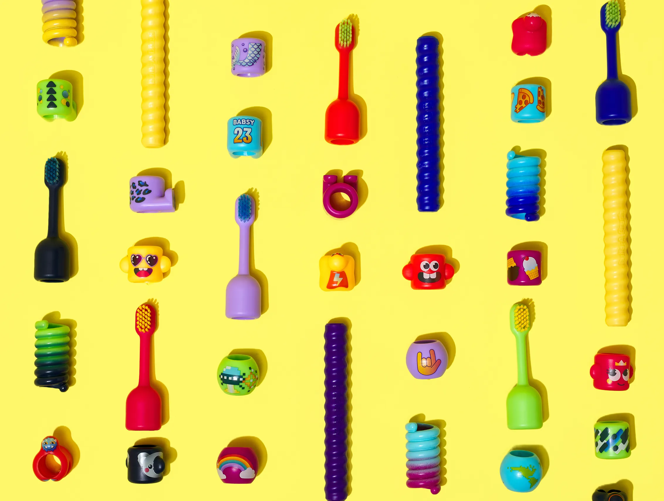 Colorful BABSY toothbrush components arranged in a product-system grid