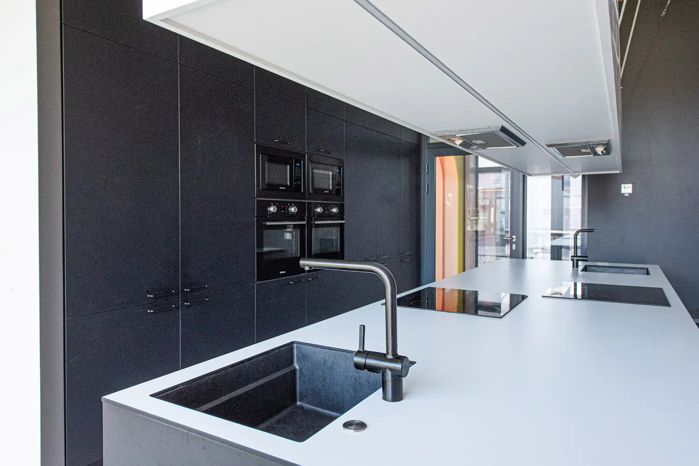 Modern shared kitchen in Vilnius student accommodation with ovens, sinks and cooking facilities.