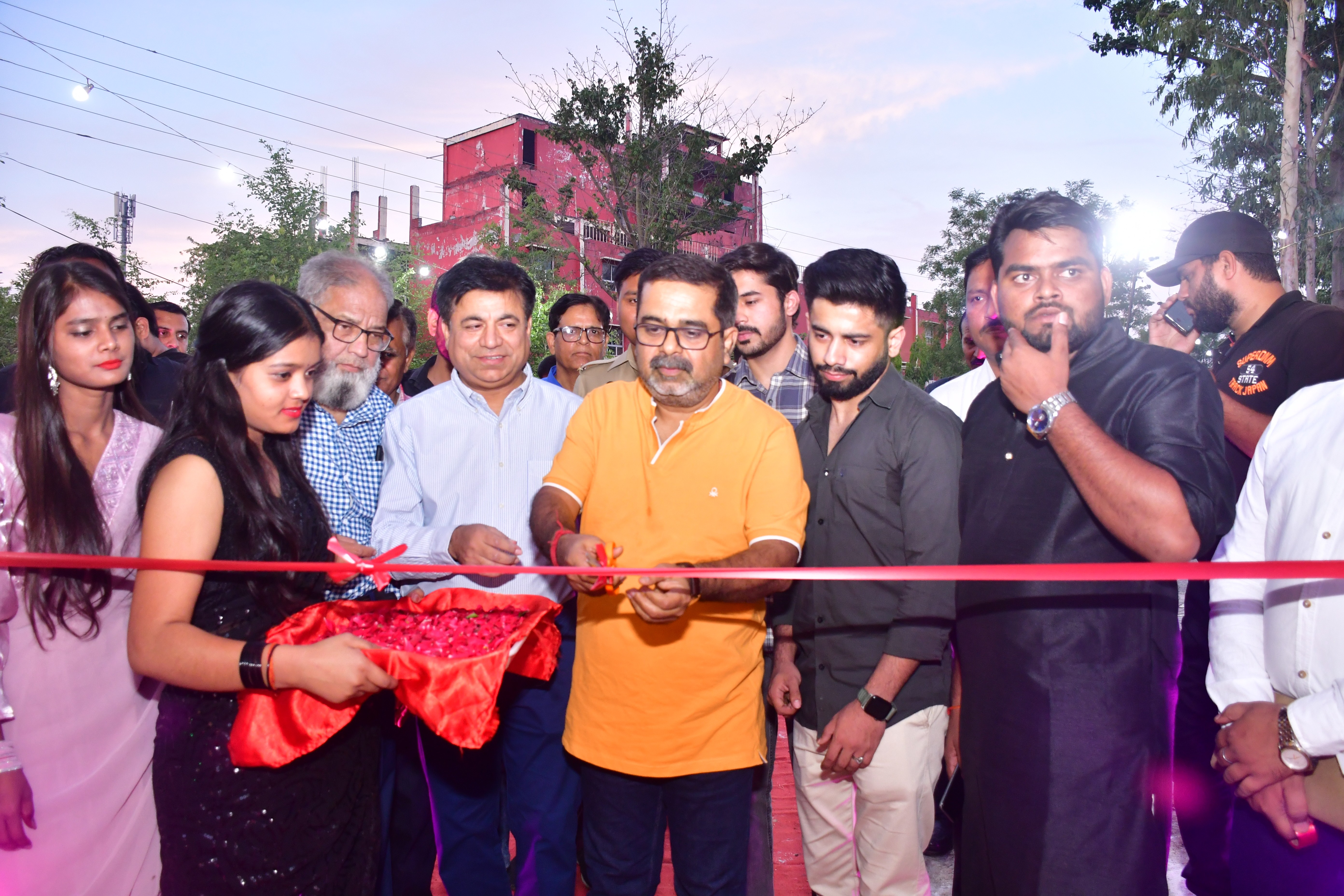 man standing in front of people sitting beside table with laptop computers