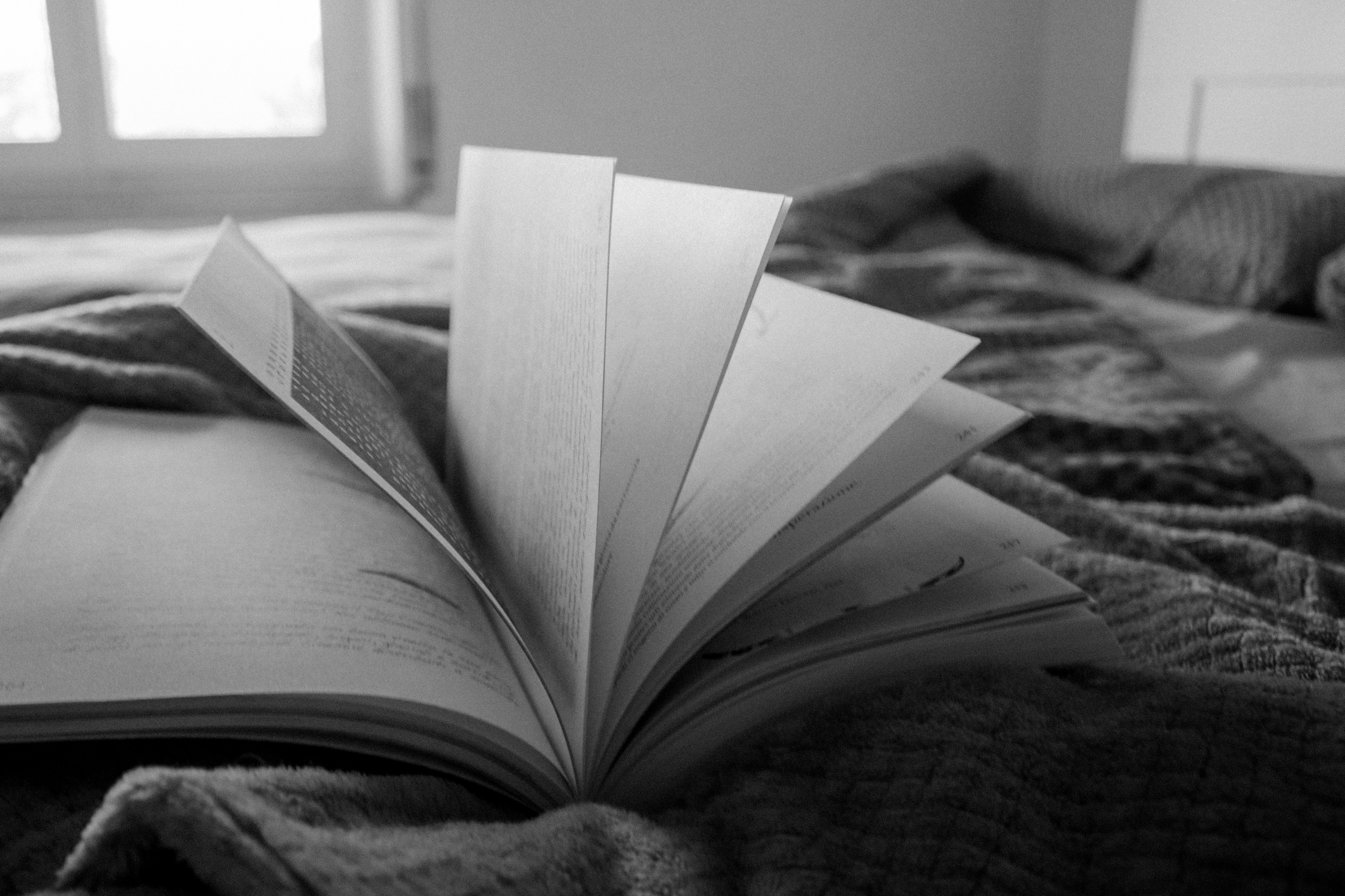 an open book sitting on top of a bad