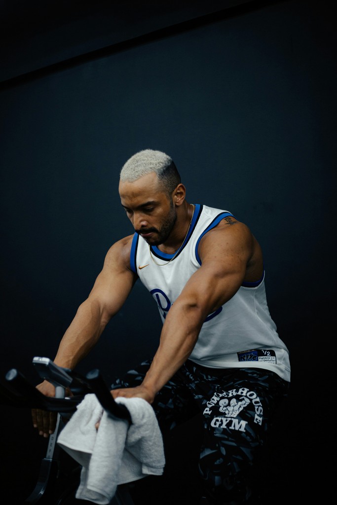 A man riding a bike while holding a towel