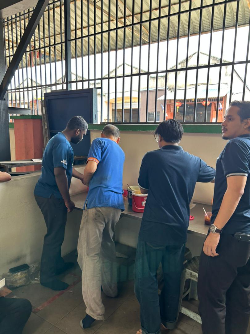 Staff lining up for the Deepavali tea break buffet, showing the diverse team at Autofill Malaysia.