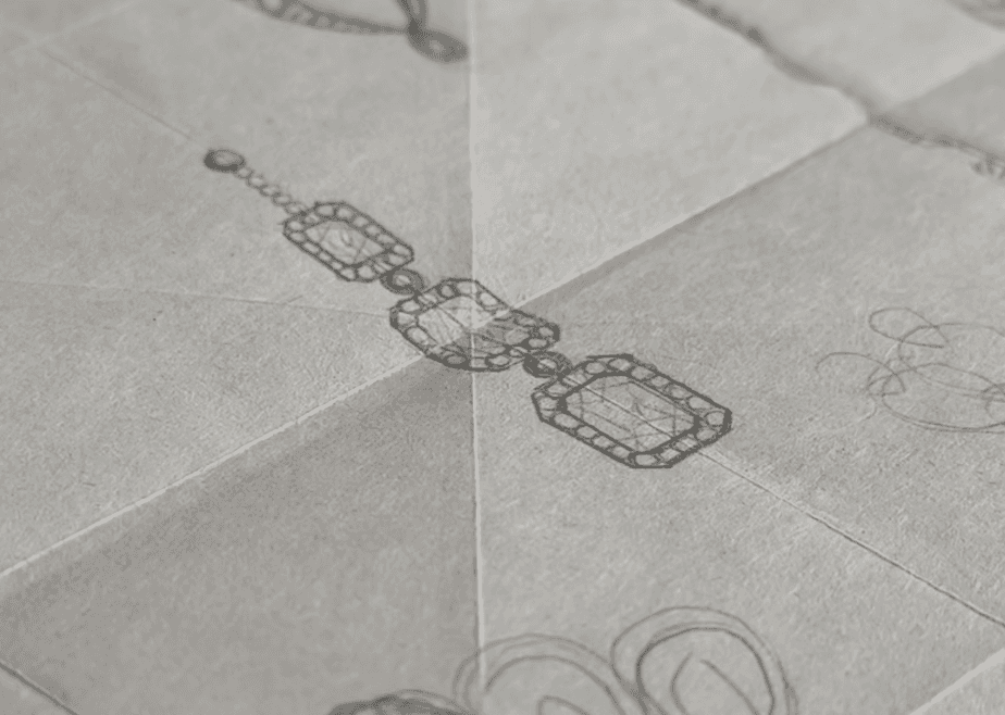 Detailed shot of a gold Tiffany & Co. necklace featuring a large geometric diamond-shaped pendant and a branded toggle clasp.