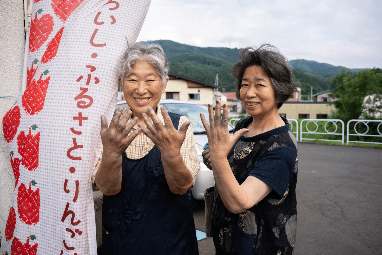 Indigo dye craftsmen showing their dyed hands