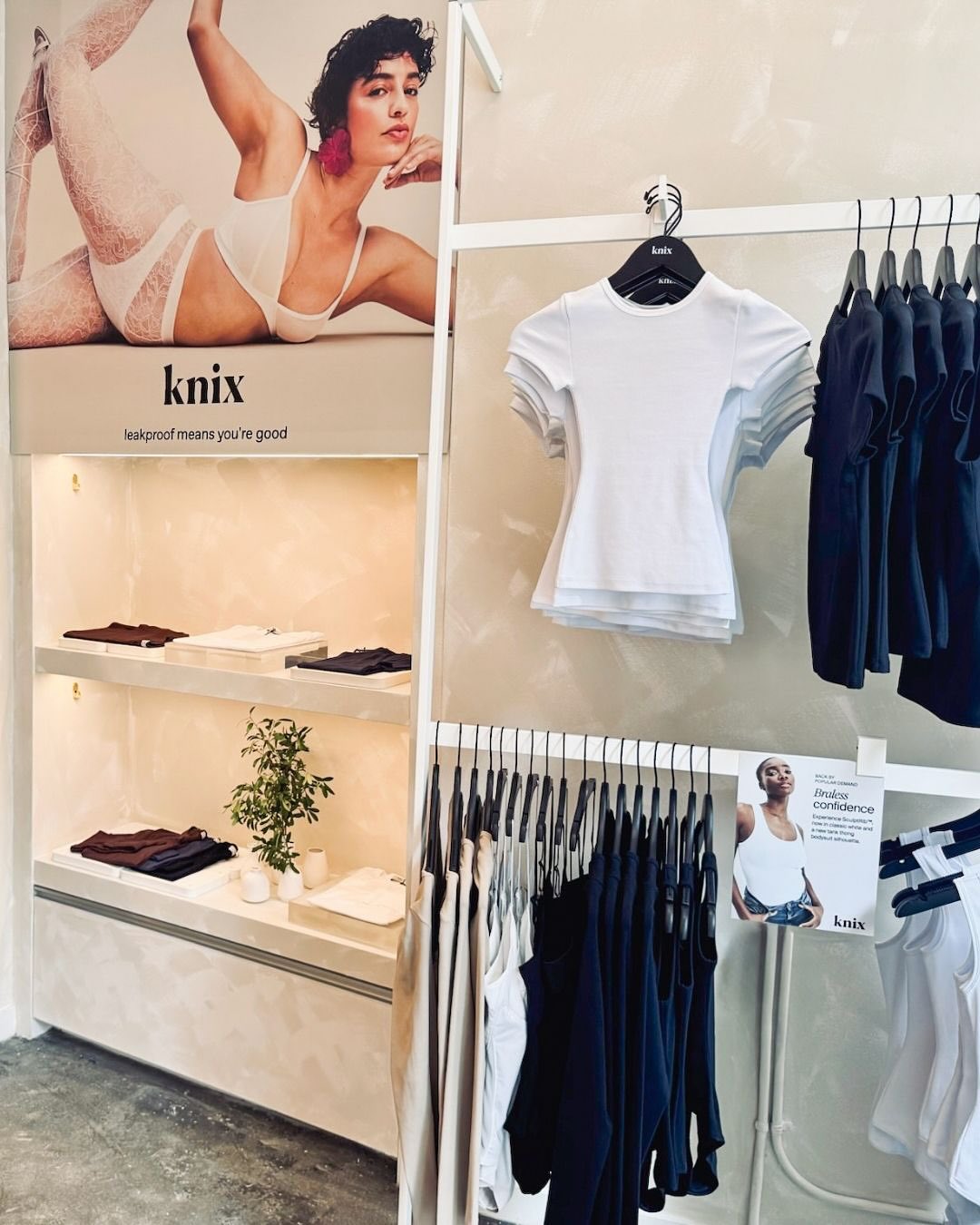 Knix retail interior with lingerie product displays and branded visual merchandising installations.