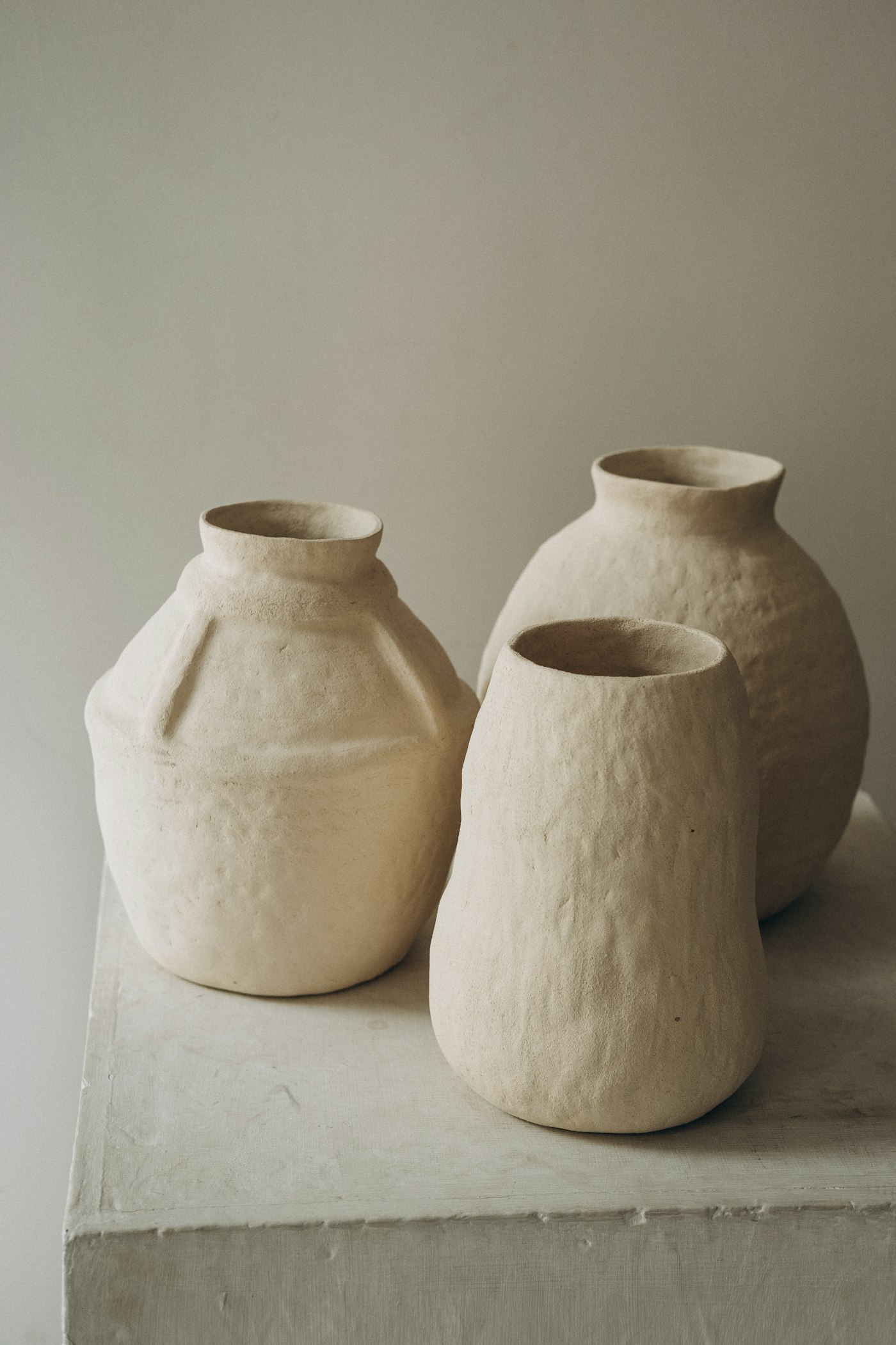 Two textured white stoneware vases