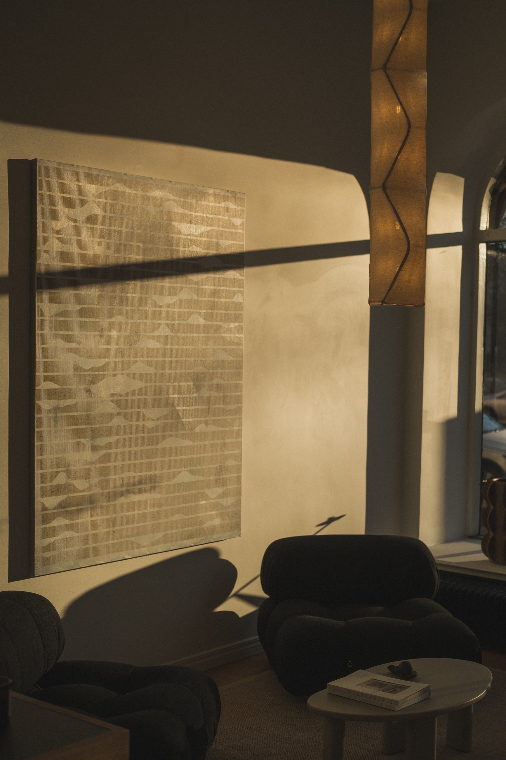 An armchair and interior details in directional window light