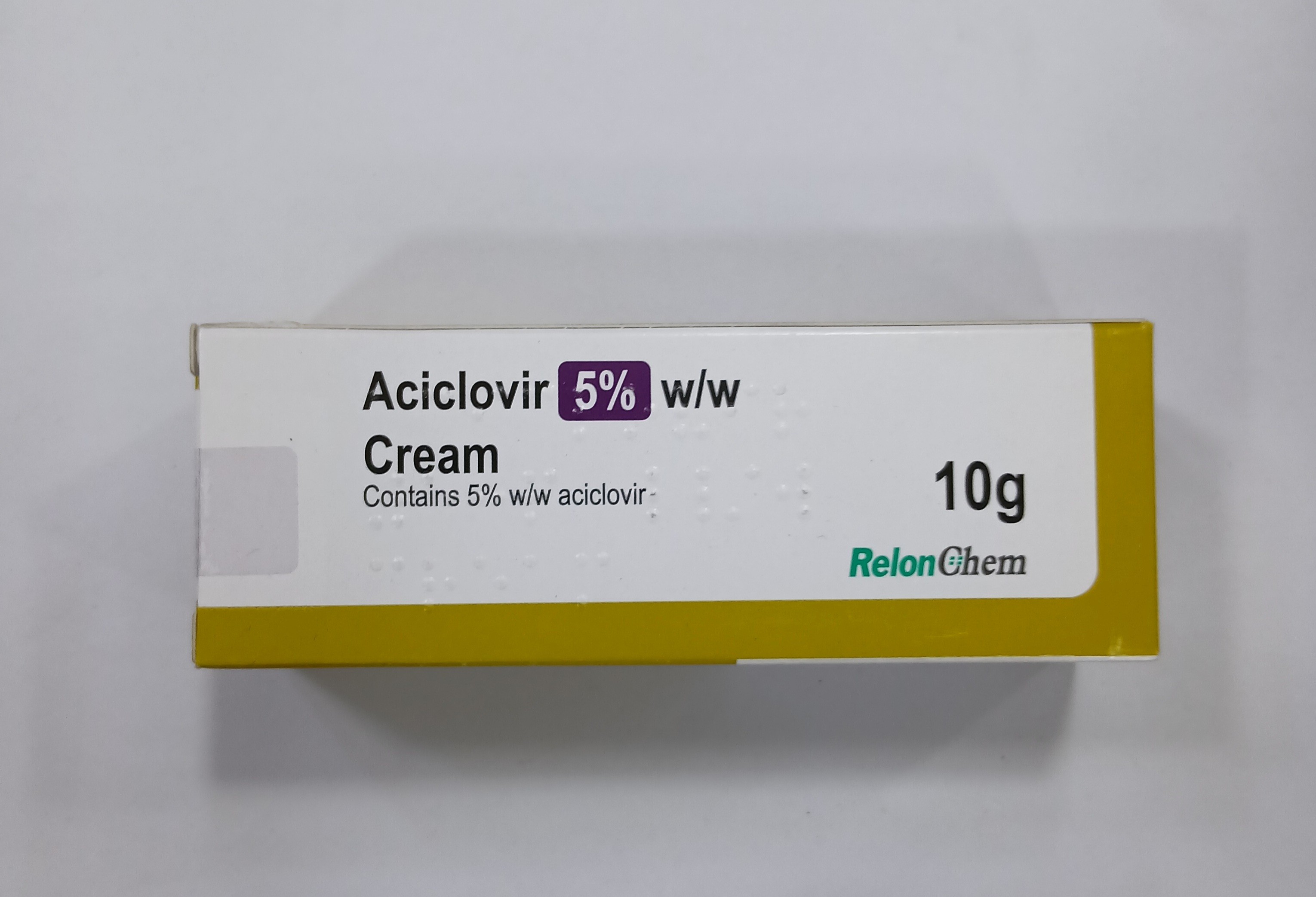A white and yellow cardboard box for Aciclovir 5% w/w Cream, containing 10g, is centered on a plain white background.