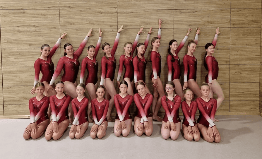 woman in black sports bra and black leggings lying on brown concrete bench