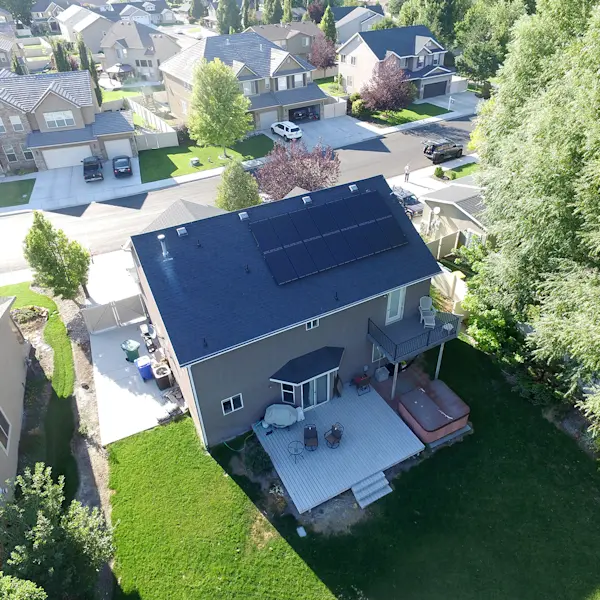 Sun glistening over a lush green landscape and solar panels