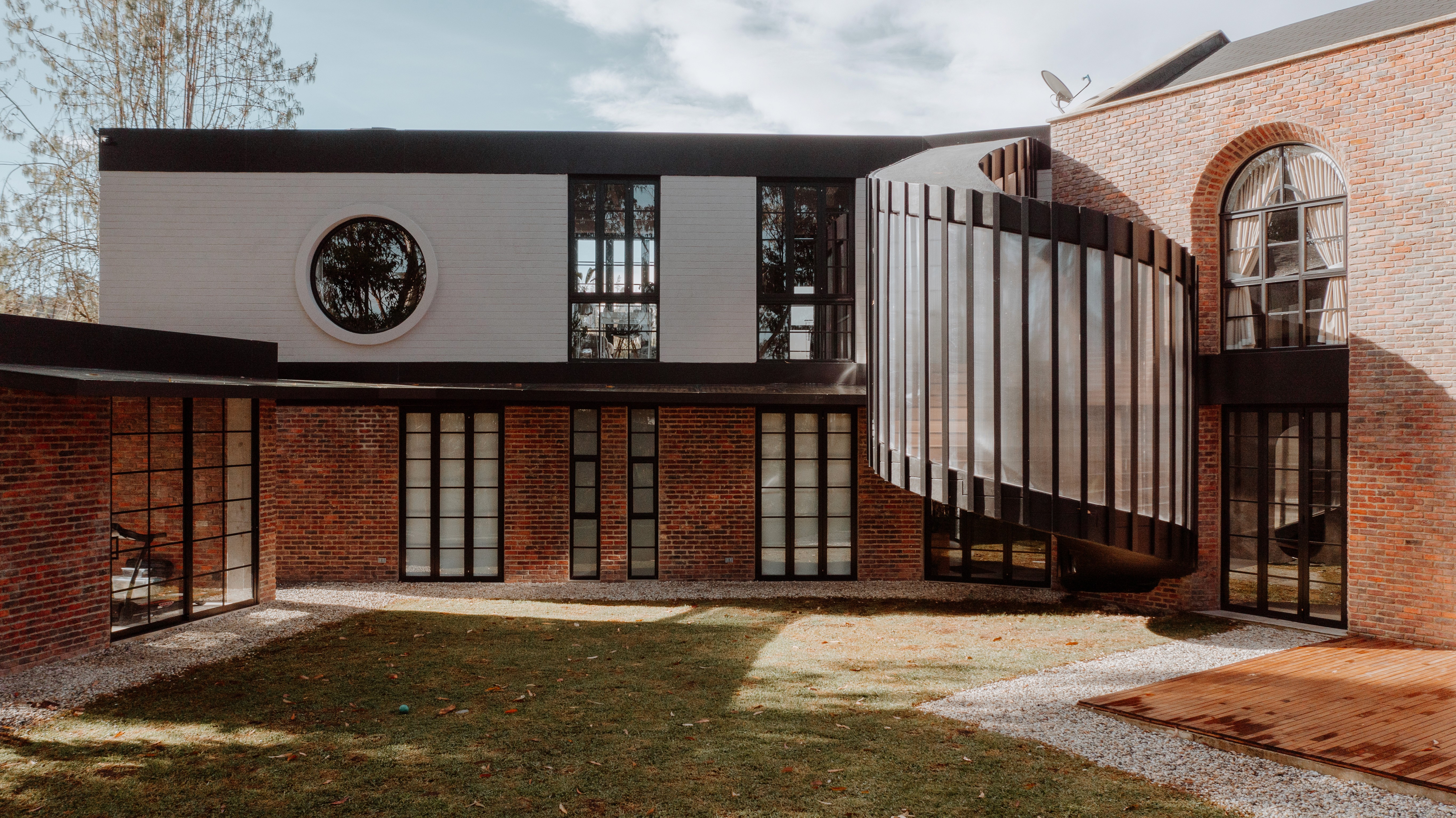 Double-height interior with flowing sculptural forms and warm raking light