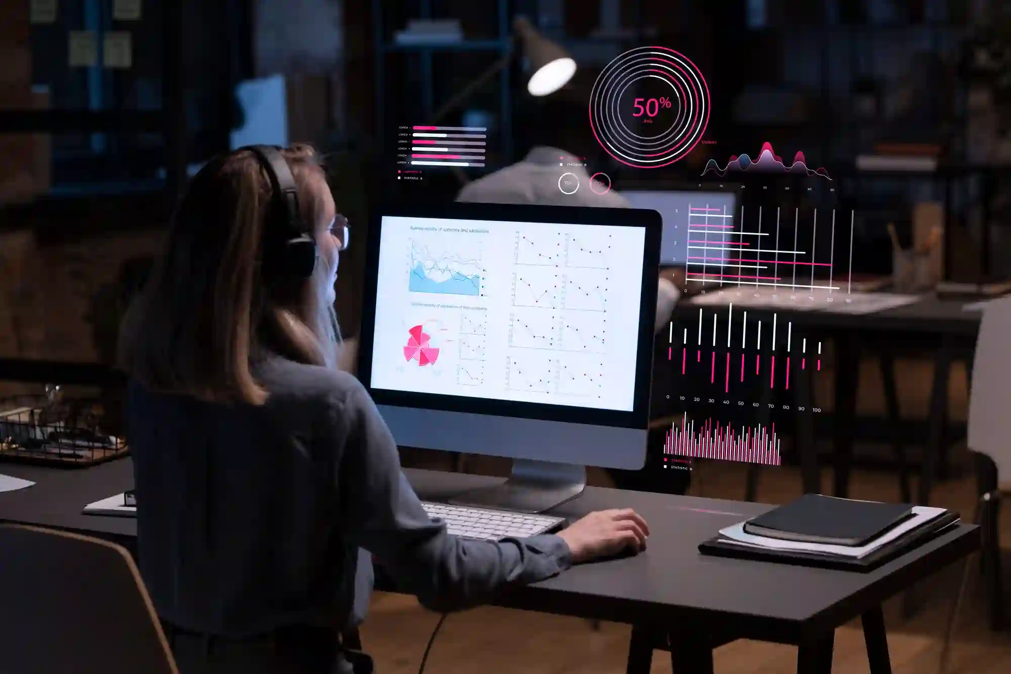 Woman analyzing complex data visualizations on a large screen, focused on late-night analytics.