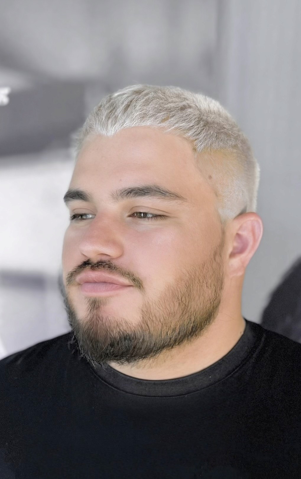 Blond hair color transformation with textured styling for men, demonstrating Barber.CLP’s luxury barbering and hair coloring services in West Hollywood.