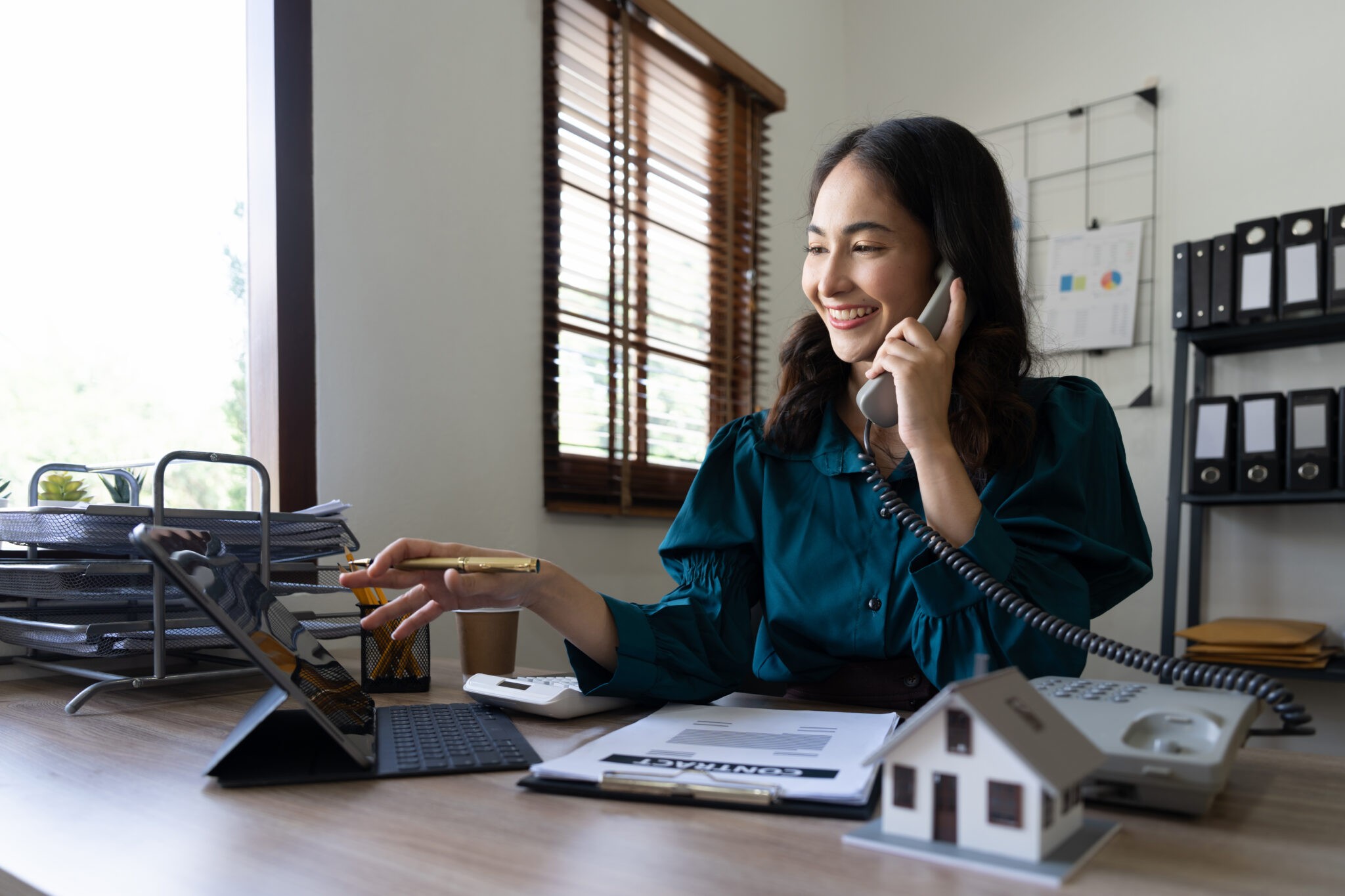A man pulls a cleaning cart near a building.