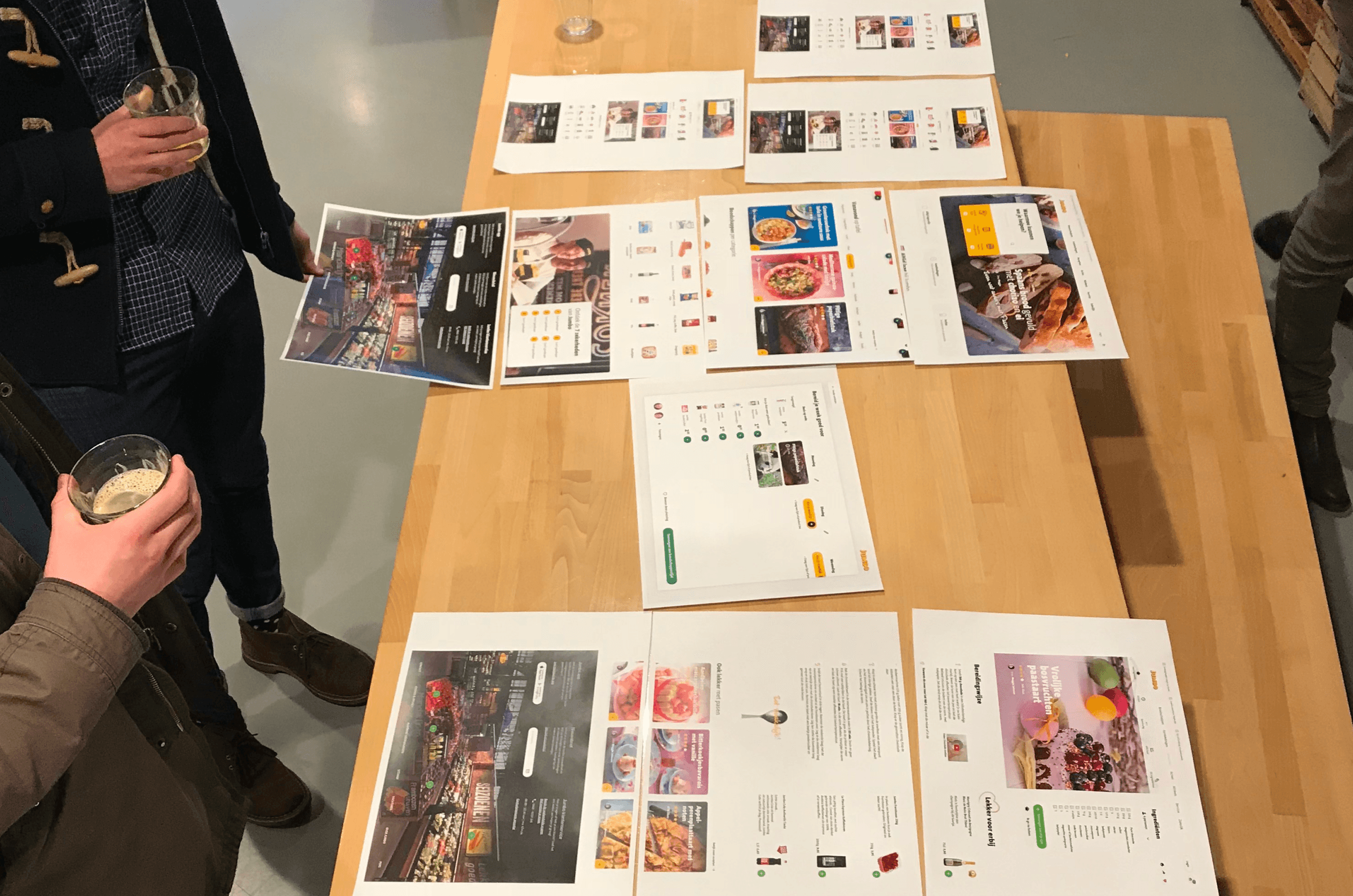 People standing in front of sketches of the redesign