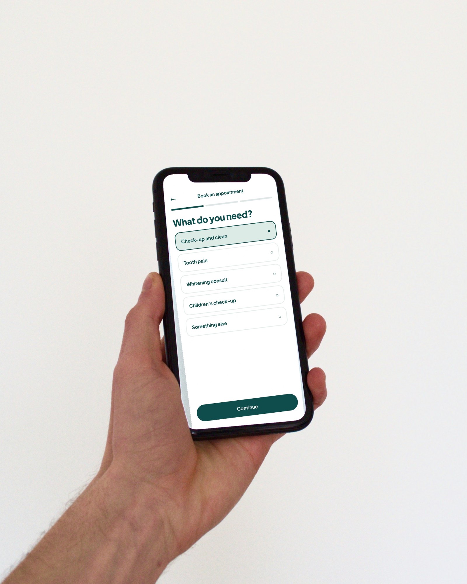 Lumi Dental concept booking screen on a phone held in a hand (concept project)