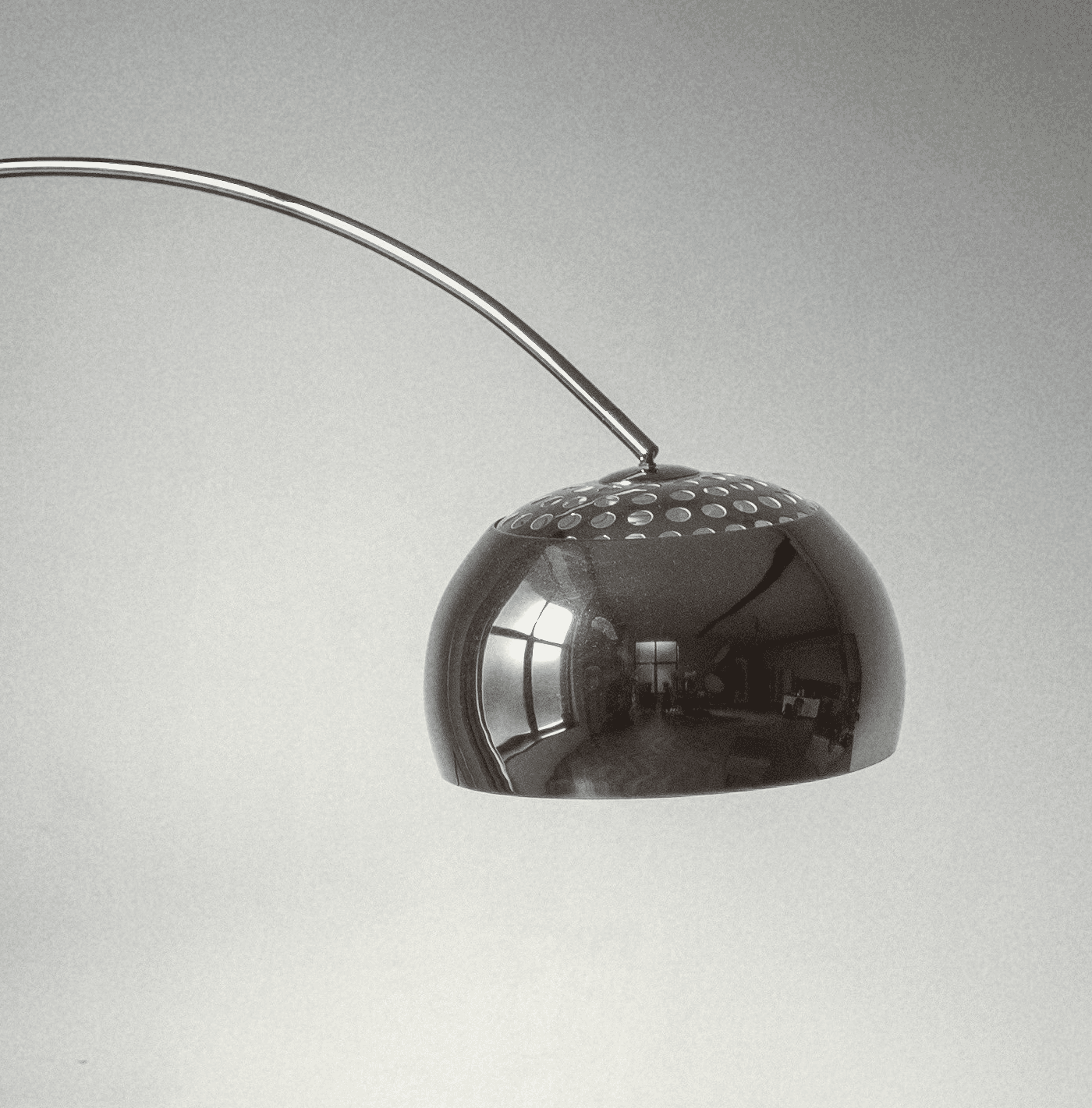 brown wooden framed white padded armchair beside white wall