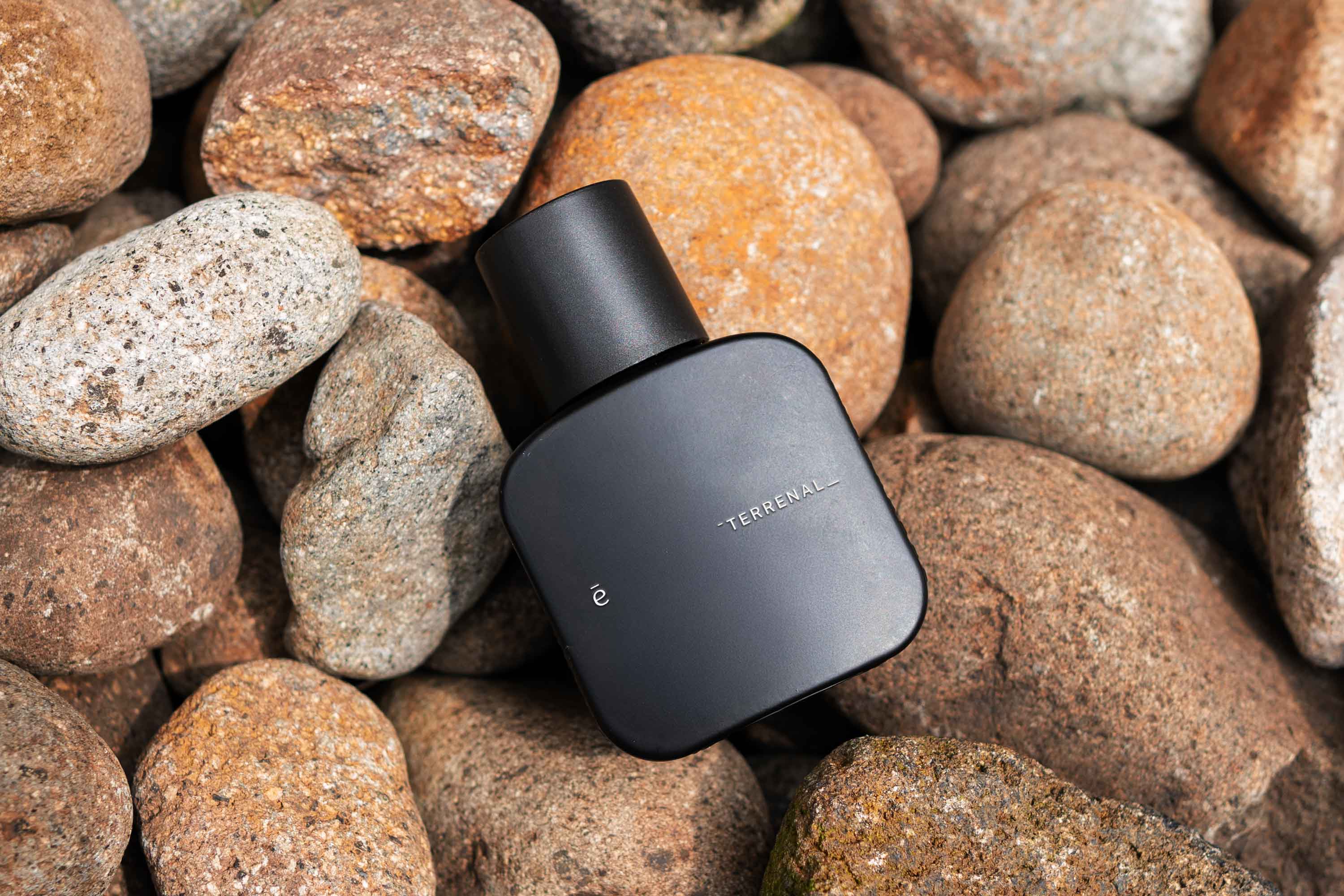 Black-and-white photo of a band rehearsal with guitarist, drummer, and people gathered under string lights.