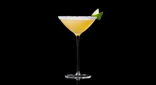 A closeup of a Marilyn Martini drink against a dark background.
