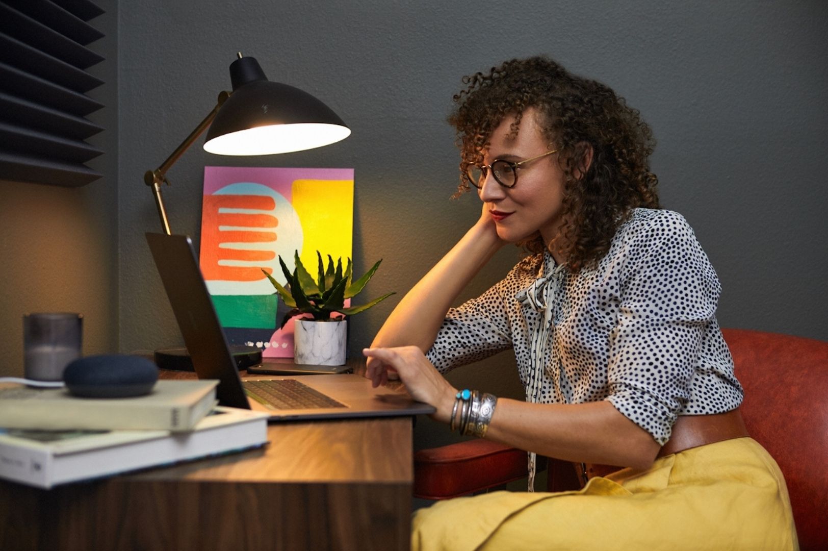 woman sitting at desk with open laptop