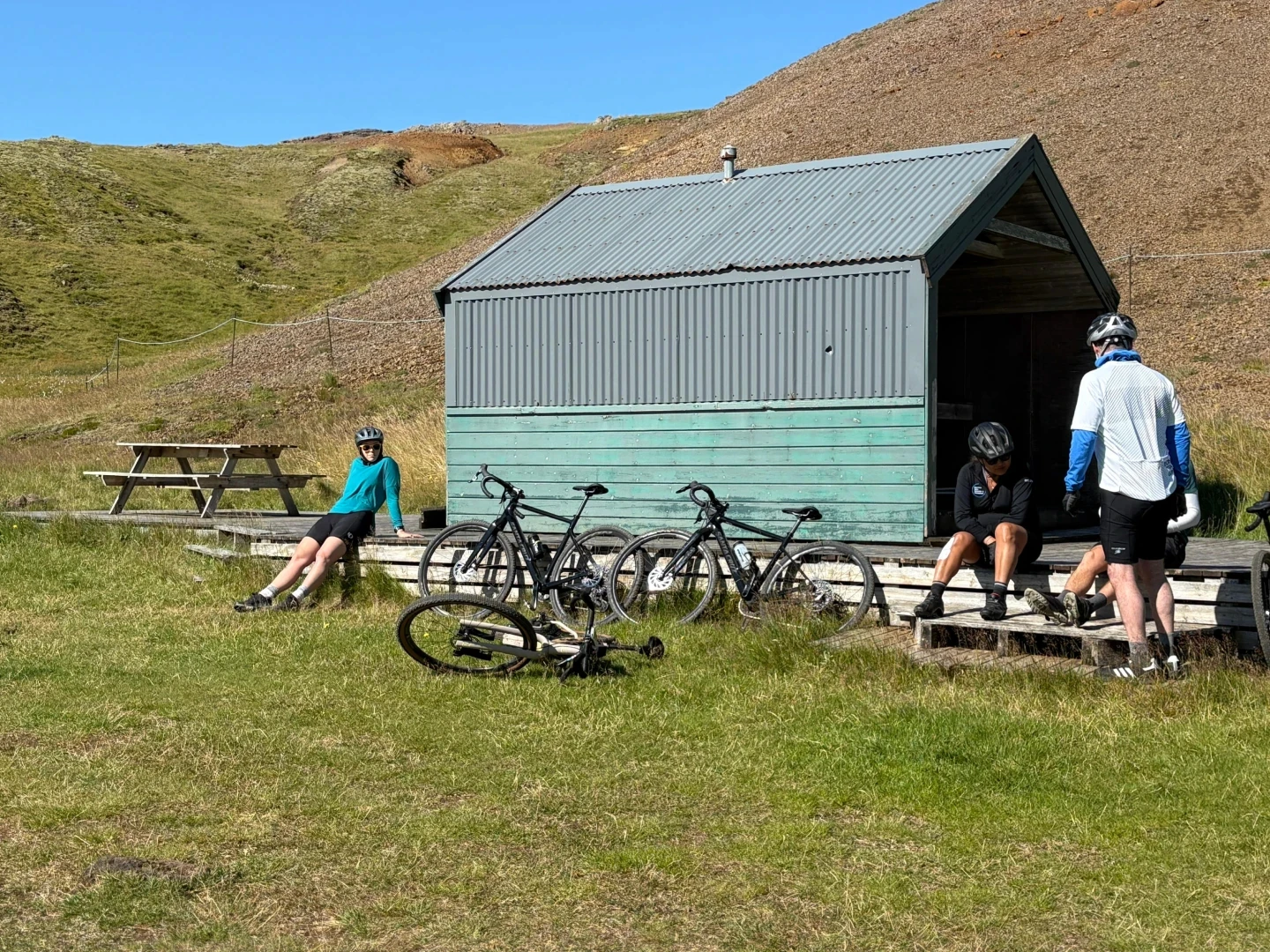 People on lunch break in front of small cabin in Iceland