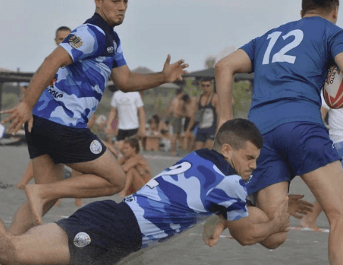 rugby tackle on a beach