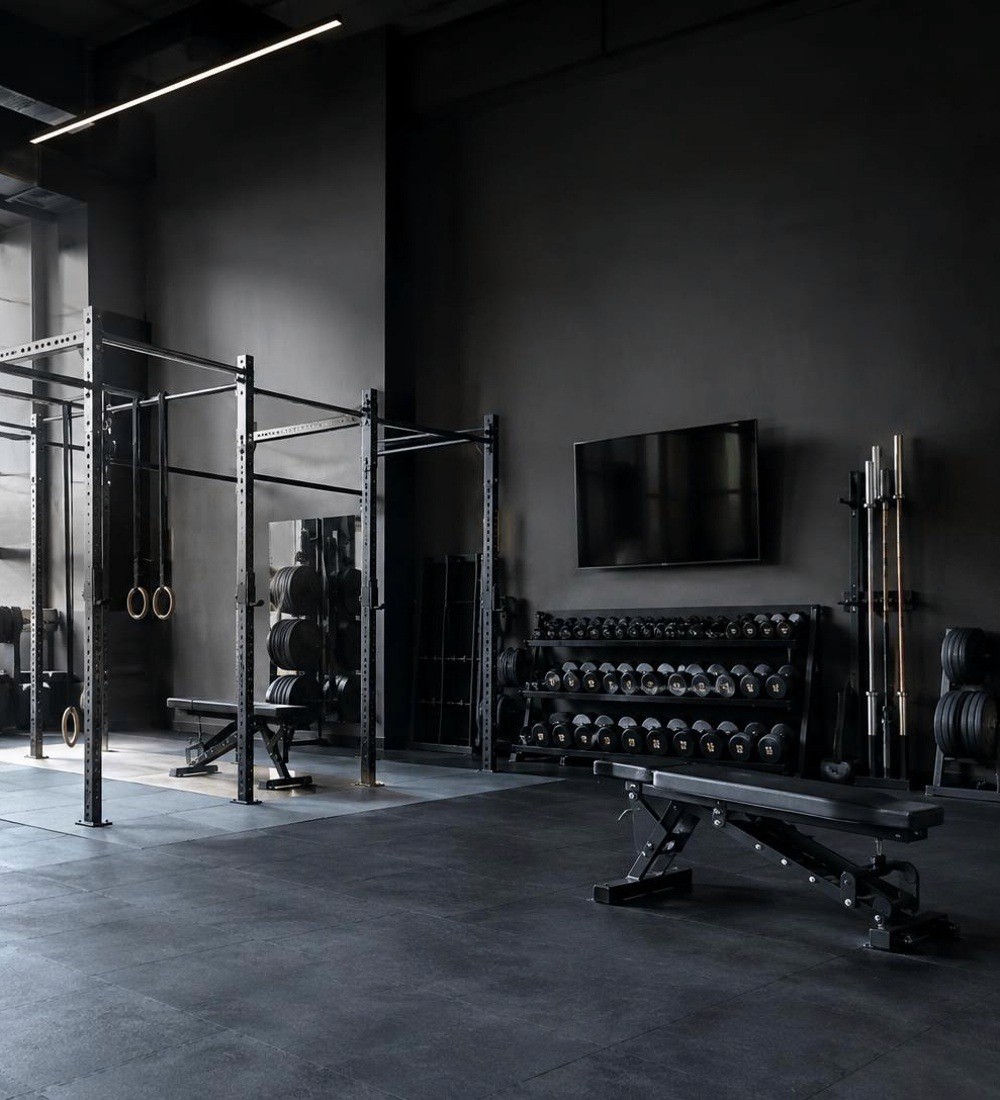 Strength area with racks, benches and dumbbells at the Manchester gym