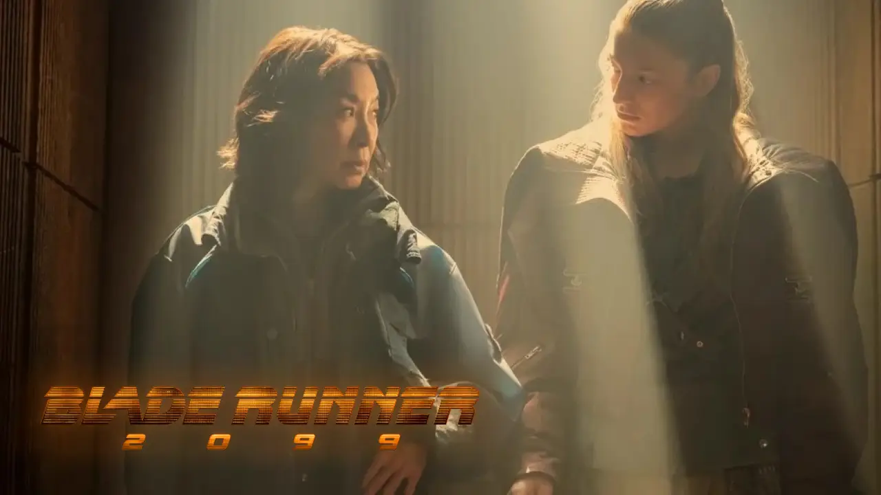Two individuals stand in a dimly lit room with beams of light illuminating their faces, featuring the logo "Blade Runner 2099" at the bottom left.